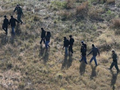 U.S. Border Patrol agents lead undocumented immigrants after capturing them near the U.S.-