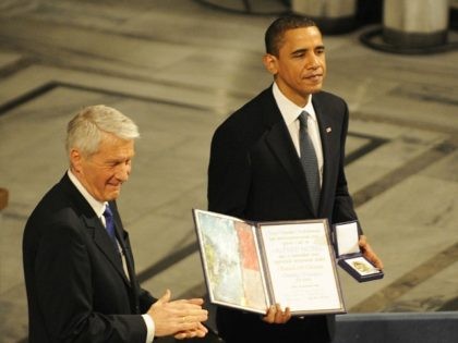 Chairman of the Norwegian Nobel Committee Thorbjoern Jagland (L) applauses as laureate, US