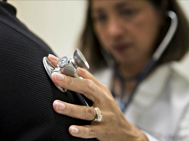 A medical doctor examines a patient with a stethoscope at a CCI Health and Wellness Servic