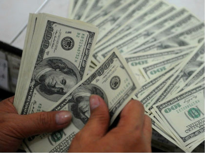 An employee at a money changer counts USD 100 bills in Manila on October 25, 2012. AFP PHO