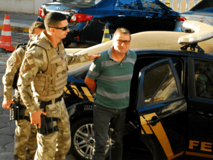 Italian ultra-leftist militant Cesare Battisti arrives escorted by police to the headquart
