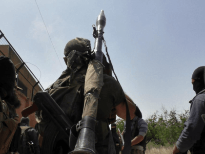 Fighters are seen during clashes with the Syrian regime Army in Mastouma, in Idlib City, S