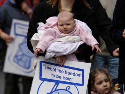 MELBOURNE, AUSTRALIA - JULY 28: A mother and her baby march during a protest on the steps