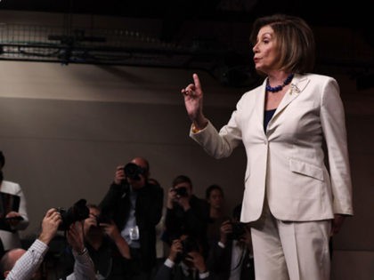 WASHINGTON, DC - DECEMBER 05: U.S. Speaker of the House Rep. Nancy Pelosi (D-CA) reacts to