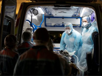Medical staff disembark from ambulances patients infected with the COVID-19 at the Gare d'
