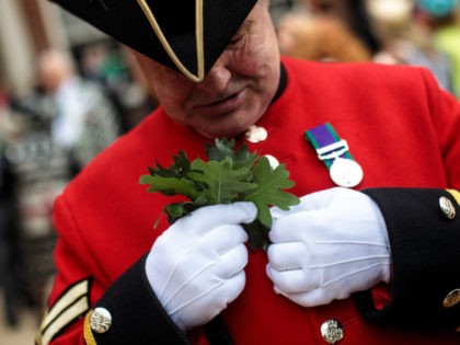 LONDON, ENGLAND - JUNE 07: A Chelsea Pensioner attaches oak leaves to his uniform ahead of