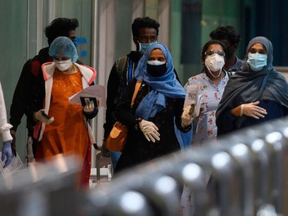 Pregnant Indian citizens evacuated from Dubai by an Air India flight arrive at the Anna In