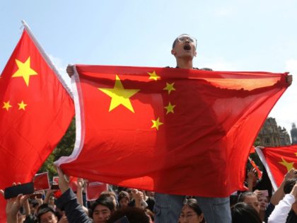 Counter-protesters hold up Chinese flags to oppose the protesters gathering in central Lon