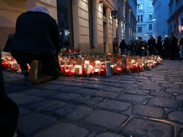 Inhabitants light candles as they pay tribute to the victims of the attack at one of the c