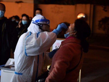 This photo taken on December 8, 2020 shows a health worker conducting a nucleic acid test