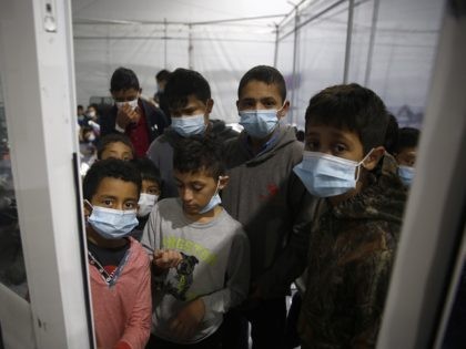 DONNA, TEXAS - MARCH 30: Young children look out from inside a pod at the Department of Ho
