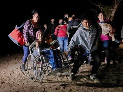 ROMA, TEXAS - APRIL 29: Honduran immigrant Trinidad Tabora, 93, is wheeled from the bank o