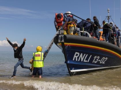 DUNGENESS, ENGLAND - AUGUST 04: A group of around 40 migrants arrive via the RNLI (Royal N