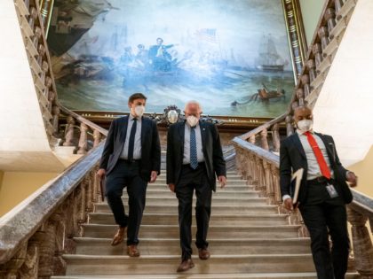 Senate Budget Committee Chairman Bernie Sanders, I-Vt., center, walks towards the Senate f