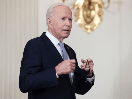 WASHINGTON, DC - SEPTEMBER 24: U.S. President Joe Biden takes off his face mask as he arri