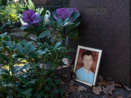 A photograph lies beside the gravestone of Russian ex-spy Alexander Litvinenko in Highgate