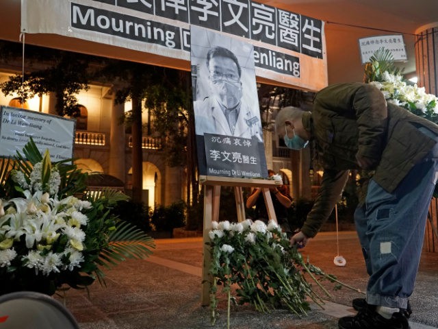 A man wearing mask, attends a vigil for Chinese doctor Li Wenliang, in Hong Kong, Friday,
