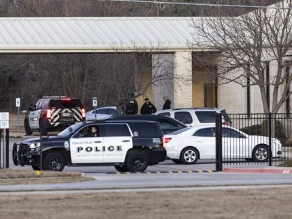 Police stand in front of the Congregation Beth Israel synagogue, Sunday, Jan. 16, 2022, in