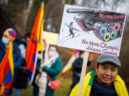 A protester holds a placard during a protest march gathering Tibetans from the Internation