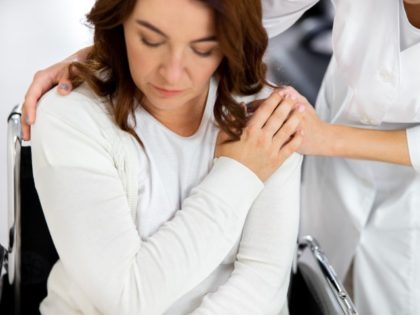 Nurse is comforting sad patient.