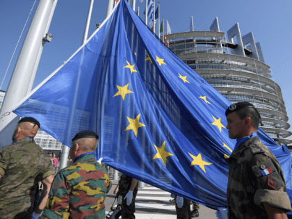 Soldiers of Eurocorps raise an European Union flag during the flag-raising ceremony on the