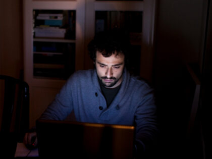 In this Feb. 17, 2012, photo, Santi Perez, 25, works on his computer at his parents home i