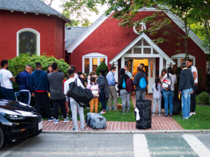 Immigrants gather with their belongings outside St. Andrews Episcopal Church, Wednesday Se