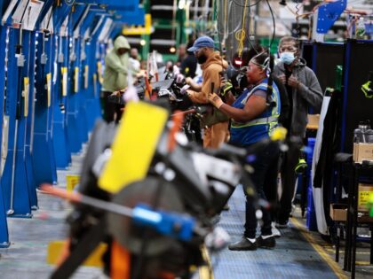Employees work on the assembly line at the Dakkota Integrated Systems manufacturing facili