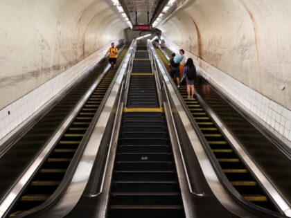 NEW YORK, NY - JULY 10: People ride on escalators at the 42nd St - Grand Central subway st