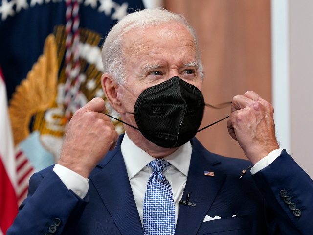 FILE - President Joe Biden removes his face mask as he arrives to speak about the economy during a meeting with CEOs in the South Court Auditorium on the White House complex in Washington, Thursday, July 28, 2022. Biden tested positive for COVID-19 again Saturday, July 30, slightly more than three days after he was cleared to exit coronavirus isolation, the White House said, in a rare case of “rebound” following treatment with an anti-viral drug. (AP Photo/Susan Walsh, File)