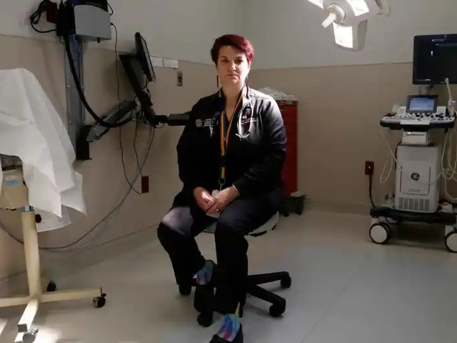 FILE - Dr. Colleen McNicholas, chief medical officer at Planned Parenthood of the St. Louis Region and Southwest Missouri, sits in a surgical room on April 11, 2022, at the Planned Parenthood clinic in Fairview Heights, Ill. Midwestern Planned Parenthood officials on Monday, Oct. 3, 2022, announced plans for a mobile abortion clinic — a 37-foot RV that will stay in Illinois but travel to near the border of adjoining states that have banned the procedure since the Supreme Court overturned Roe v. Wade earlier this year. (AP Photo/Martha Irvine, File)