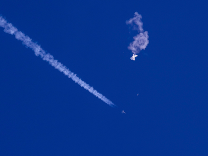 In this photo provided by Chad Fish, the remnants of a large balloon drift above the Atlan