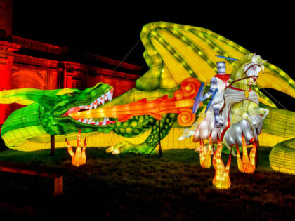 A light installation of a dragon breathes fire onto St. George in an illuminated sculpture