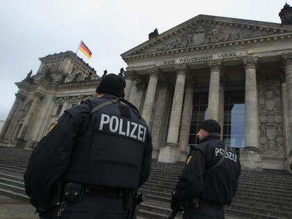 BERLIN - NOVEMBER 23: German police armed with submachine guns patrol next to the Reichsta