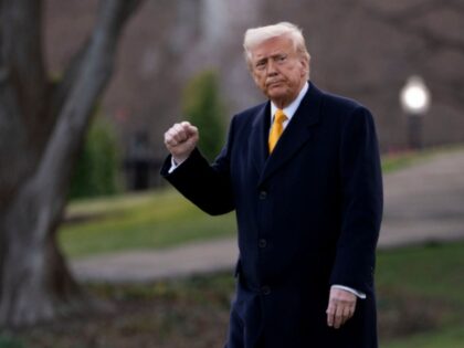 US President Donald Trump walks on the South Lawn of the White House before boarding Marin