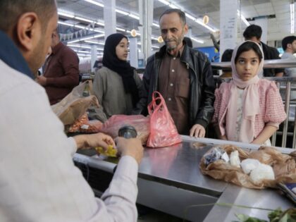 SANA'A, YEMEN - MARCH 4: Yemeni customers standing next to a cashier to pay for Ramad
