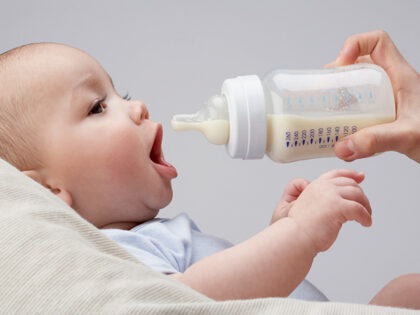 A baby being fed a bottle