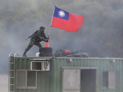 A soldier holds a Taiwanese national flag during a military exercise in Hsinchu County, no