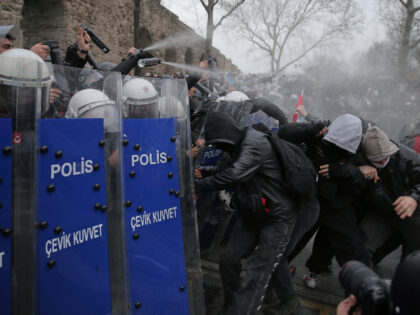 Riot police officers clash with protesters during a protest after Istanbul's Mayor Ek