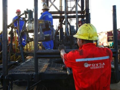 Workers of the State oil Company of Venezuela, Venezuelan oil Company SA (PDVSA), walks ne