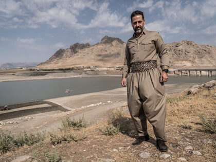 Qubad Talabani is standing next to Lake Dukan on October 1, 2024. Qubad Talabani is the cu