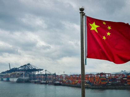 SHENZHEN, CHINA - APRIL 12: A Chinese national flag is seen in the foreground with contain