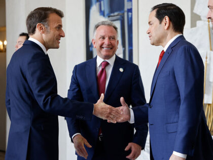 France's President Emmanuel Macron (L) shakes hands with US Secretary of State Marco