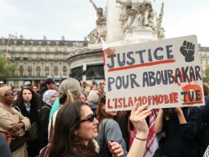 A protestor holds a sign reading "Justice for Aboubakar, Islamophobia kills" during a gath