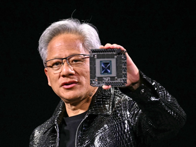 Jensen Huang of Nvidia holding an AI chip