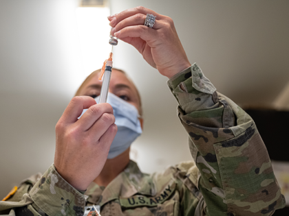 FORT KNOX, KY - SEPTEMBER 09: A Preventative Medicine Services technician fills a syringe