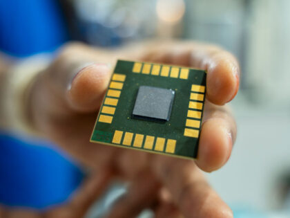 A person displays a computer chip in a stall during The Advantage Assam 2.0 Investment Sum
