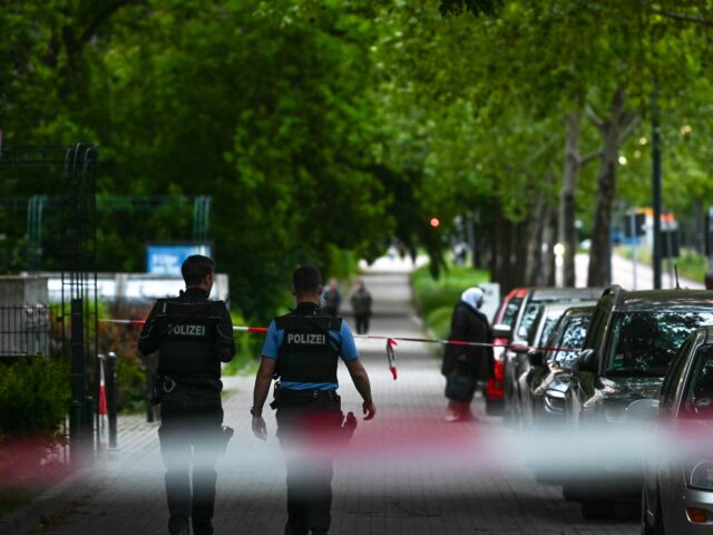 18 May 2025, Saxony-Anhalt, Halle (Saale): Police officers walk along the scene. There was