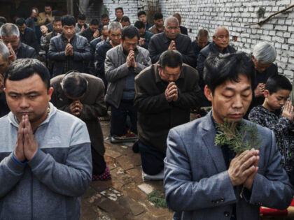 SHIJIAZHUANG, CHINA - APRIL 09: (CHINA OUT) Chinese Catholic worshippers kneel and pray du